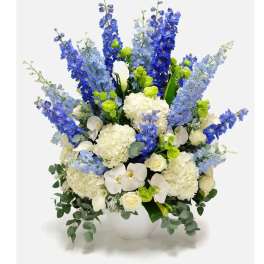 Blue and white floral arrangement in a white vase