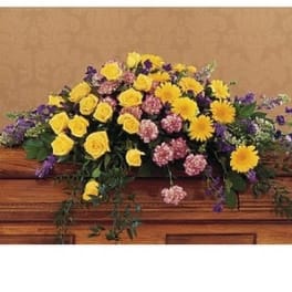 Casket spray with yellow roses, yellow daisies, and pink carnations