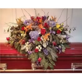 Colorful floral spray on a red casket