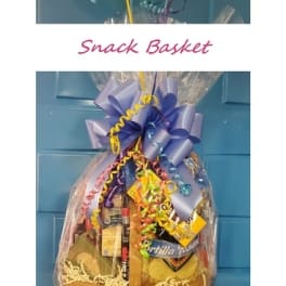 Gift basket wrapped in clear cellophane with a large purple bow