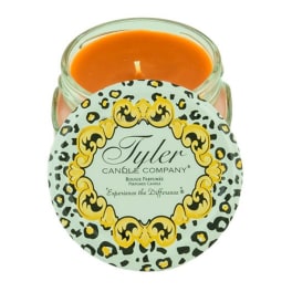 Orange candle in a glass jar with a patterned lid