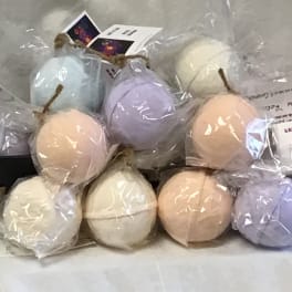 Wrapped pastel spherical bath bombs tied with twine