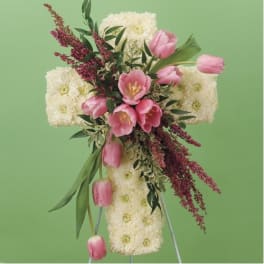 Cross-shaped floral arrangement with pink tulips and white blooms