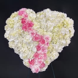 Heart-shaped floral arrangement of white and pink carnations