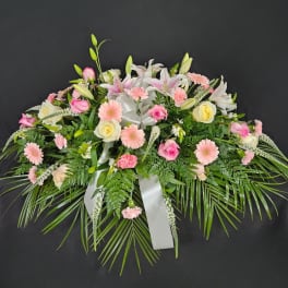 Pink and white floral spray with lilies, roses, and daisies