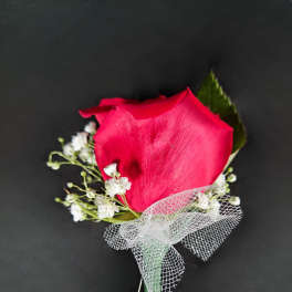 Single red rose boutonniere with white baby's breath and mesh ribbon