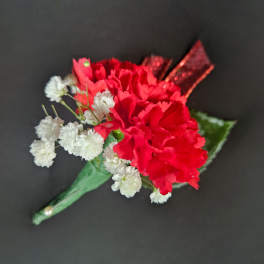 Red carnation boutonniere with white baby's breath on a green wrap