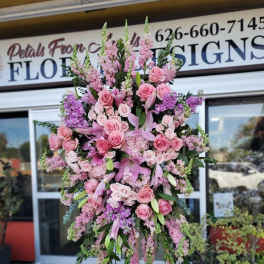 Large pink floral standing spray on an easel