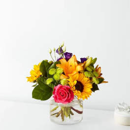 Bouquet of mixed flowers in a clear glass vase