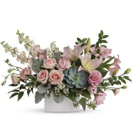 Pink roses and lilies in a white rectangular vase