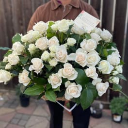Large basket of white roses held by a person