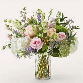 Mixed bouquet of pink and white flowers in a clear glass vase