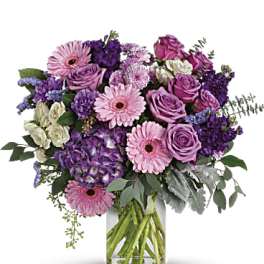 Pink and purple mixed bouquet in a clear glass vase