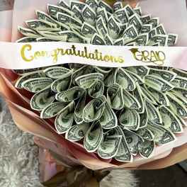 Bouquet made of folded one-dollar bills with a congratulations ribbon