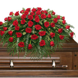 Red rose casket spray on a wooden casket