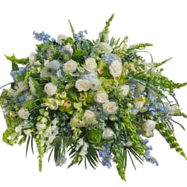 Large white and blue floral spray with roses and mixed blooms