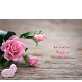 Pink roses with a small heart-shaped note on a wooden surface