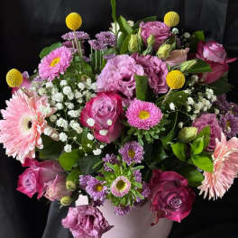 Pink and purple mixed bouquet in a white vase