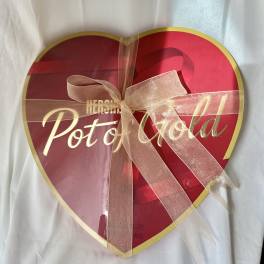 Heart-shaped box of Pot of Gold chocolates tied with a ribbon