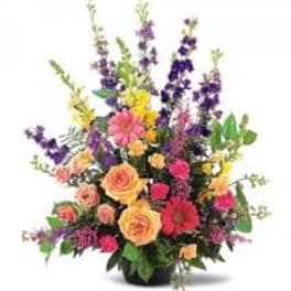 Colorful mixed flower arrangement in a black vase
