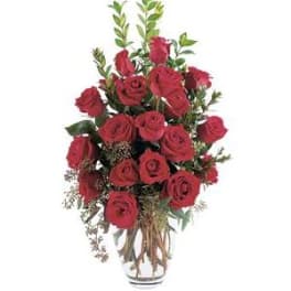 Red roses arranged in a clear glass vase