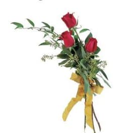 Three red roses tied with a yellow ribbon