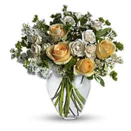 Bouquet of cream and white roses in a clear glass vase