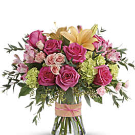 Pink and yellow rose bouquet in a glass vase