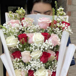 Large bouquet of pink, red, and white roses with baby's breath