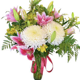 Bouquet of pink lilies and white chrysanthemums in a glass vase