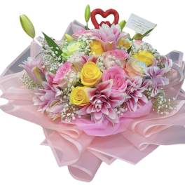 Pink and yellow bouquet with roses and lilies wrapped in pink paper