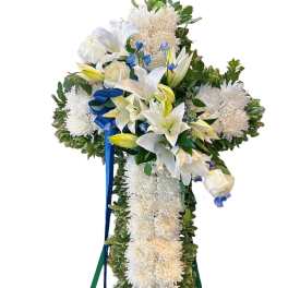 White floral standing cross with blue ribbon accents