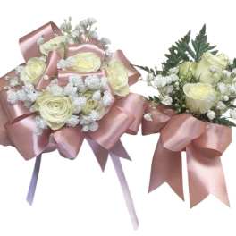 Two small rose bouquets wrapped with pink satin ribbon