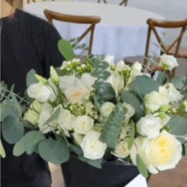 White rose bouquet with eucalyptus in a black wrap