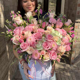 Large pink bouquet in a white hatbox with ribbon