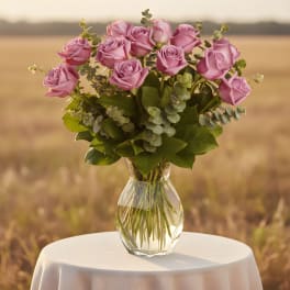 Pink roses arranged in a clear glass vase
