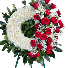 Heart-shaped floral wreath with red roses and white flowers