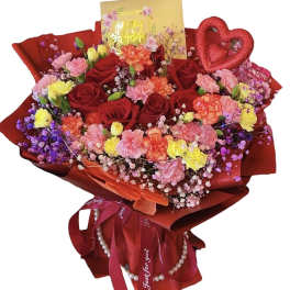 Bouquet of red roses and mixed pastel flowers with a heart decoration