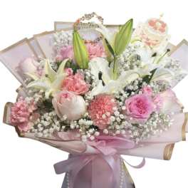 Pink and white bouquet with lilies, roses, and carnations wrapped in pastel paper