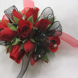Red rose corsage with black ribbon and clear gems