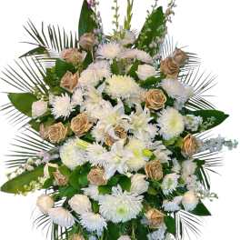 Large white and gold funeral spray with roses and lilies