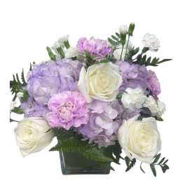 Lavender hydrangeas and white roses in a square glass vase