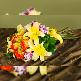 Bouquet of yellow lilies and orange roses with pink accents