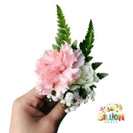Small pink and white floral corsage held in a hand