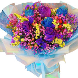 Bouquet of multicolored roses and small filler flowers wrapped in blue paper