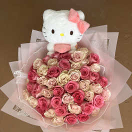 Bouquet of pink and cream roses with a Hello Kitty plush topper