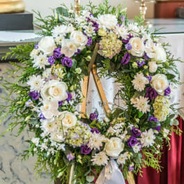 Large floral wreath with white roses and purple flowers