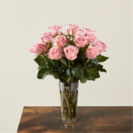 Pink roses arranged in a clear glass vase