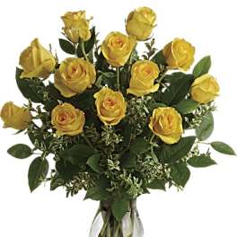 Yellow roses arranged in a clear glass vase