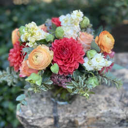 Bouquet of coral, pink, and white flowers with greenery